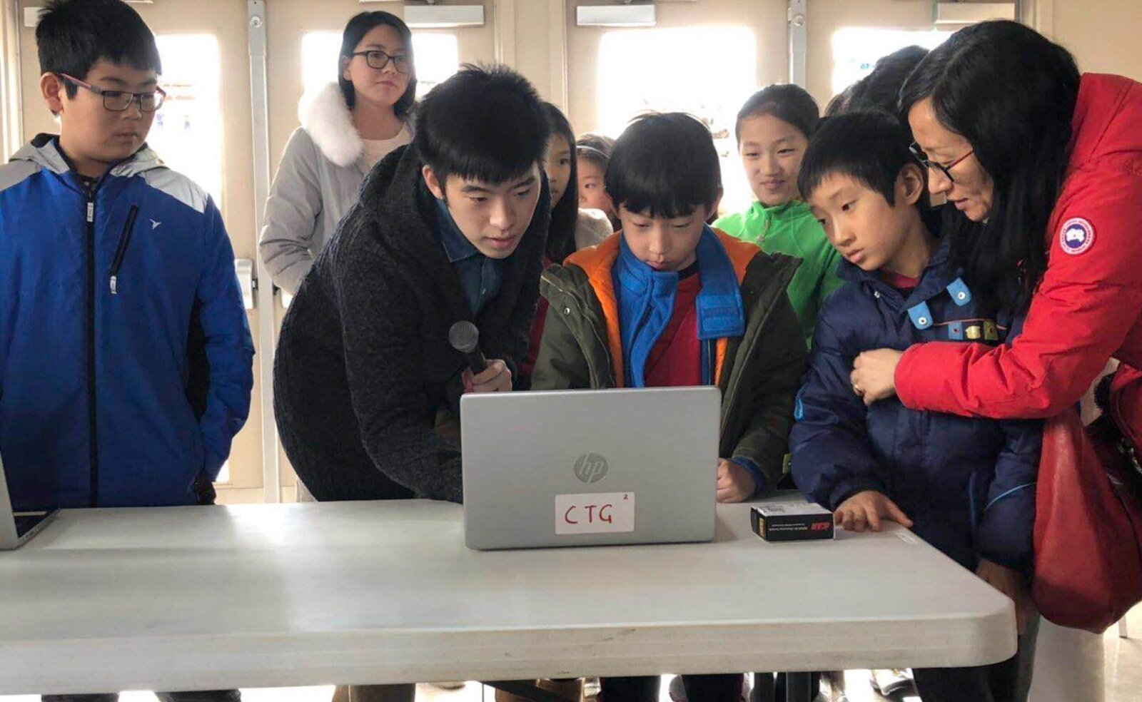Young participants viewing a computer project demonstration