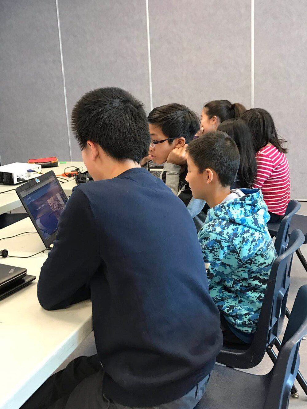 Young learners working together at computers